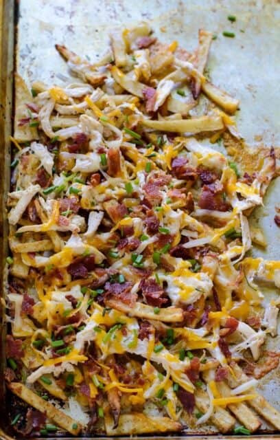 Overhead view of chicken bacon ranch fries on a sheet pan