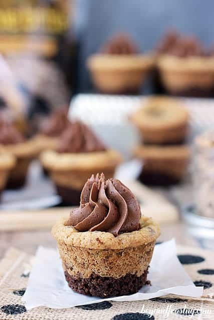 One Brownie Brittle Toffee Crunch Cookie Cups on a piece of parchment paper