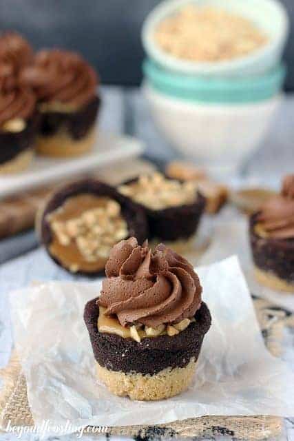 A few Snickers Cookie Cups topped with a swirl of Chocolate Buttercream.