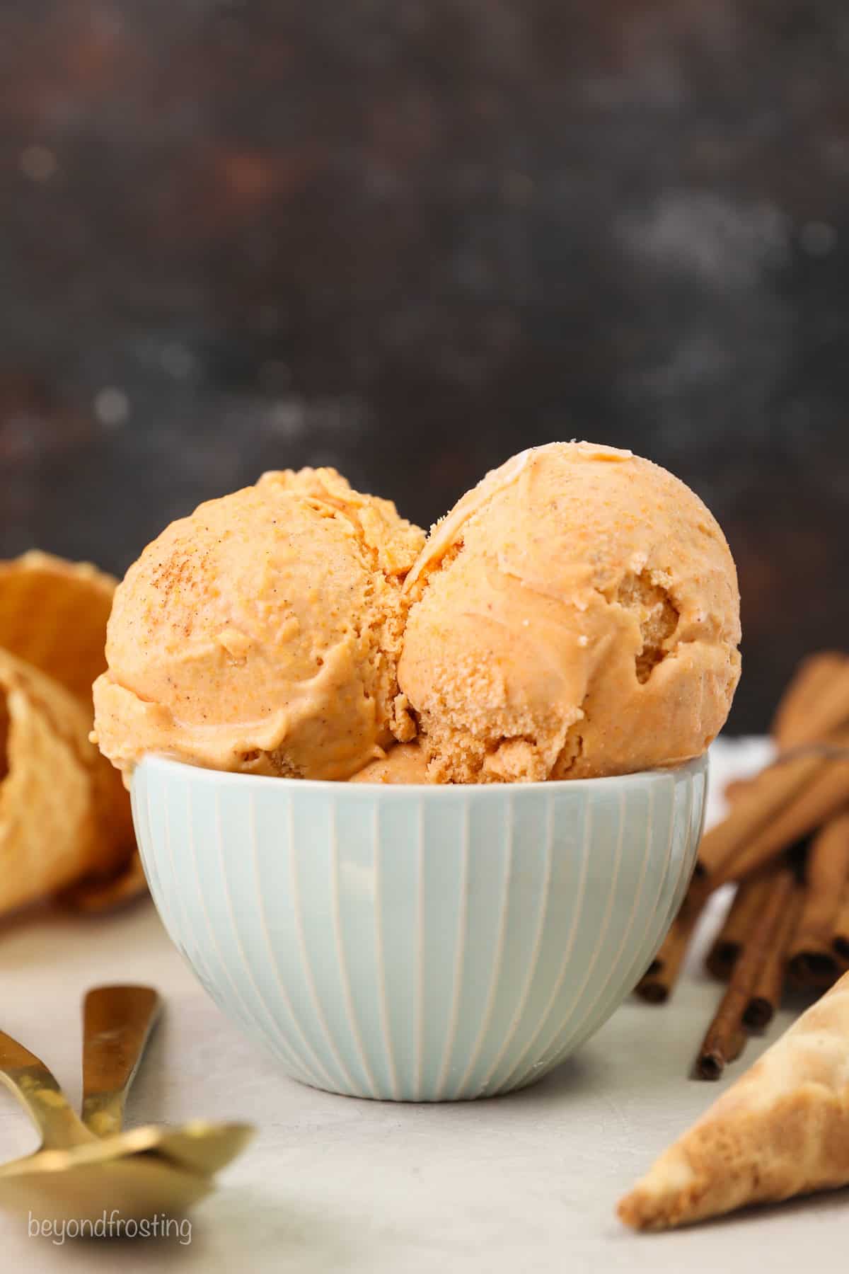 Two scoops of sweet potato ice cream in a white bowl.