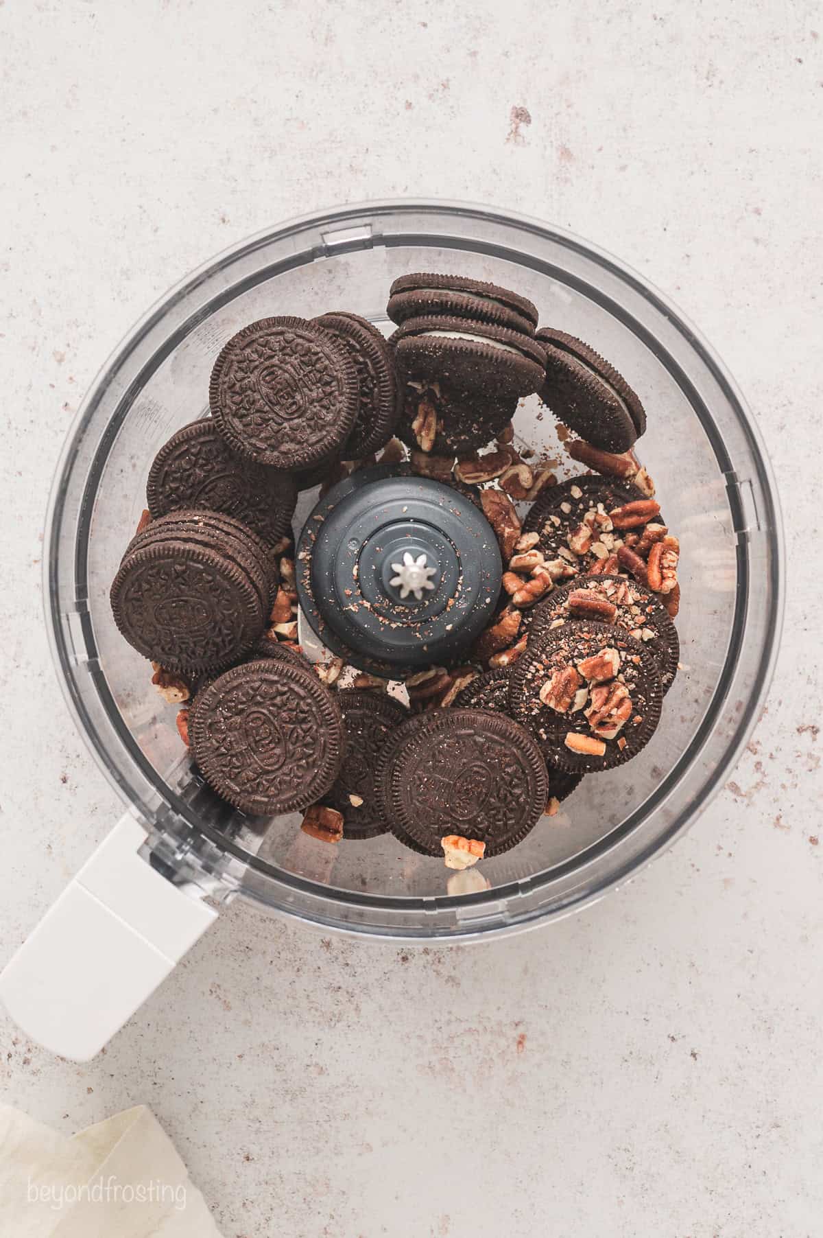 Oreos and pecans combined in a food processor.