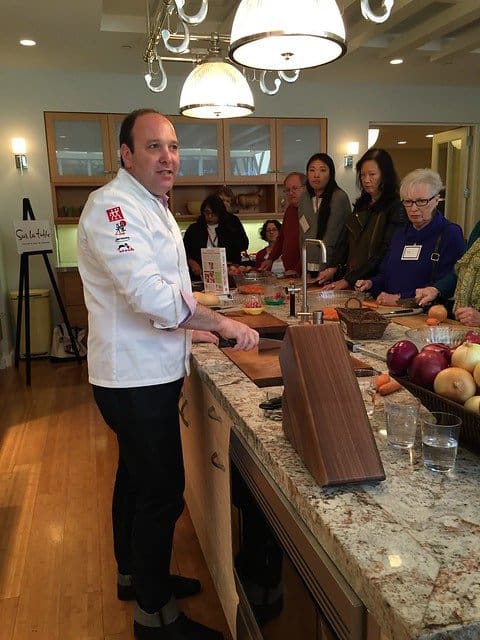 Chef Jeffery Elliot giving a knife demonstration in a kitchen