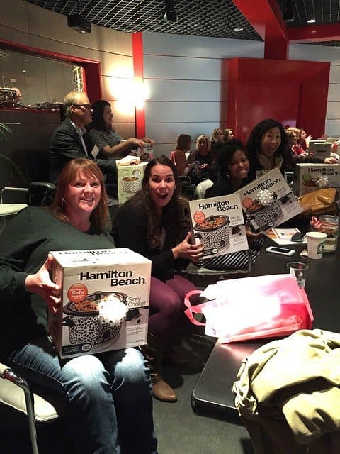 A group of food bloggers in an audience showing new slow cookers