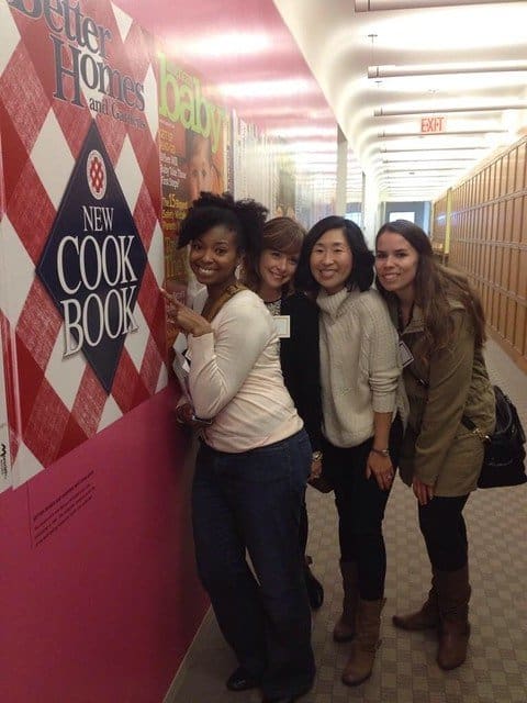 Four food bloggers posing next to BHG Cookbook posters