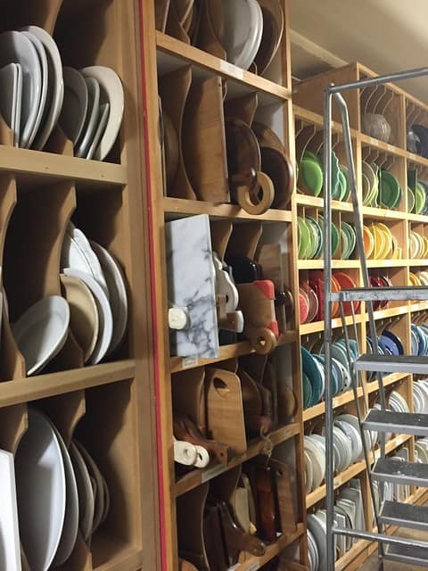 Shelves of cutting boards and colorful dishes