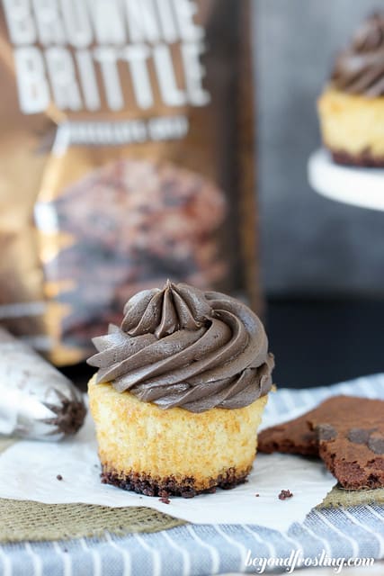 A browie brittle smores cupcake on a napkin in front of a bag of brownie brittle