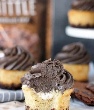These smores cupcakes are filled with cream marshmallow, topped with chocolate marshmallow filling, and are coated in brownie brittle on the bottom.