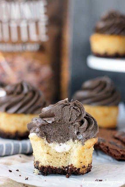 These smores cupcakes are filled with cream marshmallow, topped with chocolate marshmallow filling, and are coated in brownie brittle on the bottom.