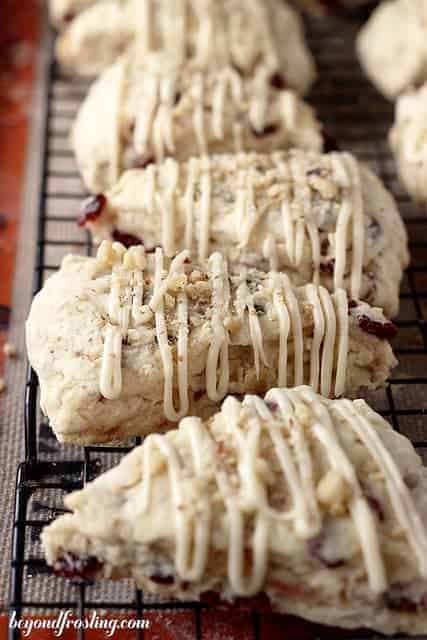 5 Cranberry Maple Walnut Scones resting on a wire cooling rack.