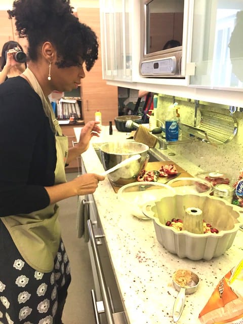 A woman preparing a cranberry bundt cake in the kitchen