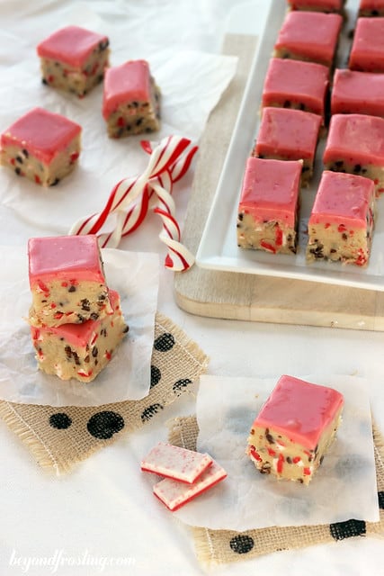 Andes Peppermint Crunch Cookie Dough Truffle Bars on parchment paper next to a tray of bars
