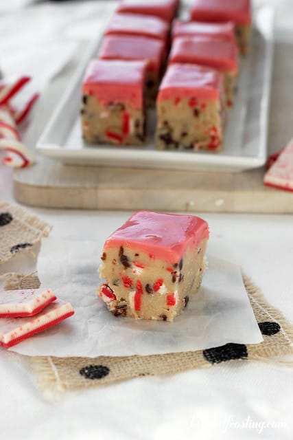 Close-up of an Andes Peppermint Crunch Cookie Dough Truffle bar on a napkin in front of a platter of bars