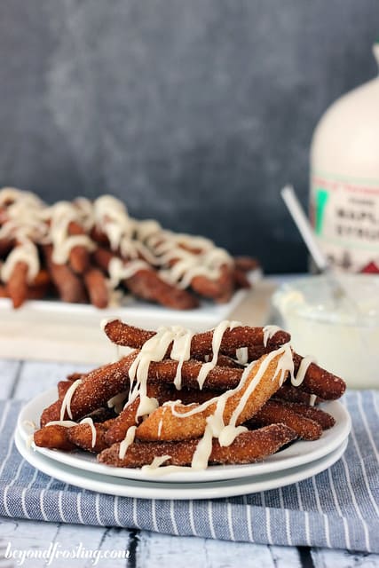 Cinnamon Sugar donut fries on a plate with drizzled frosting