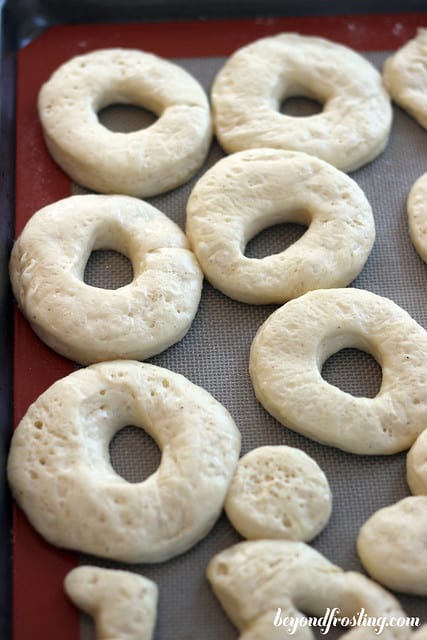 Donut dough rings on a baking mat