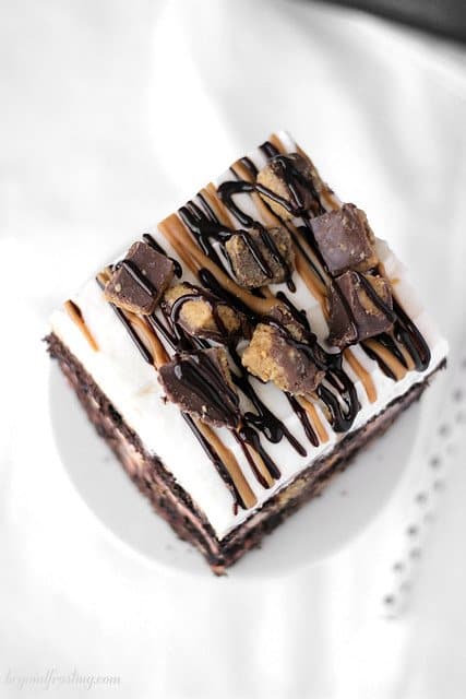 Overhead view of a square of Chocolate Peanut Butter Cup Lasagna on a mini cake stand