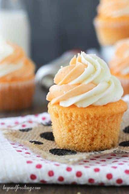 An orange cream cupcake topped with frosting.
