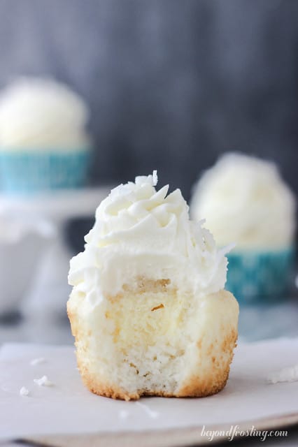 An unwrapped Coconut Cream Pie Cupcake on a napkin with a bite removed