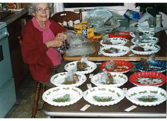 Grandmother packaging up Christmas cookies at a table