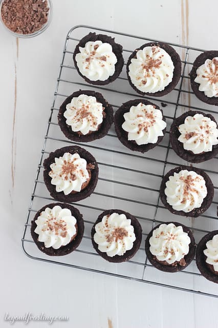 Overhead view of Chocolate Cream Pie Cookie Cups on a cooling rack with one missing