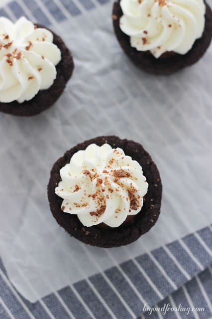 Overhead view of three Chocolate Cream Pie Cookie Cups on a napkin