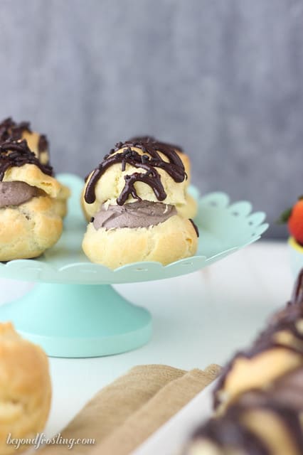 Chocolate cream puffs on a cake stand