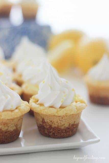 These Lemon Cream Pie Cookie Cups will knock you socks off. Full of lemon flavor, these cookie cups have an easy lemon mousse filling and topped with Fresh Whipped Cream.