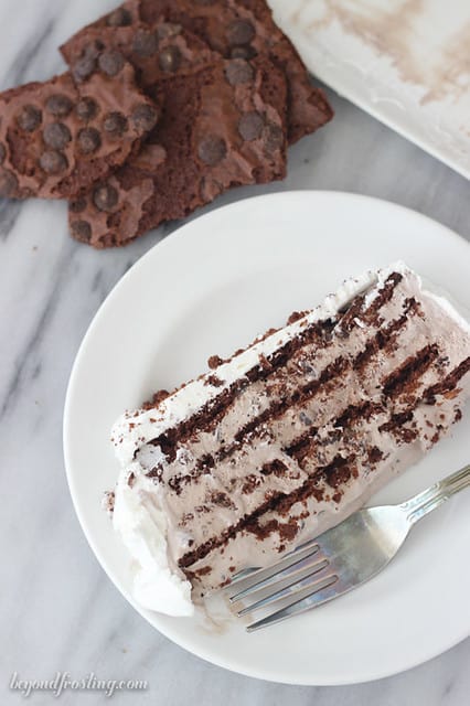 Overhead view of a slice of Brownie Brittle Icebox Cake on a plate with layers of chocolate and cream