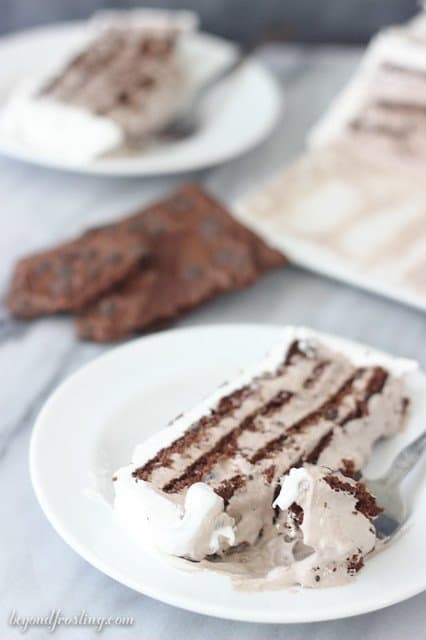 A slice of Brownie Brittle Icebox Cake on a plate with a bite on a fork