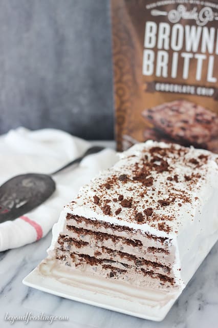 Overhead view of Brownie Brittle Icebox Cake on a platter with layers of chocolate and cream