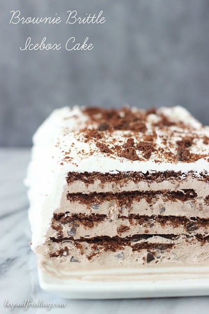 Brownie Brittle Icebox Cake on a platter with a slice cut to show layers of chocolate and cream