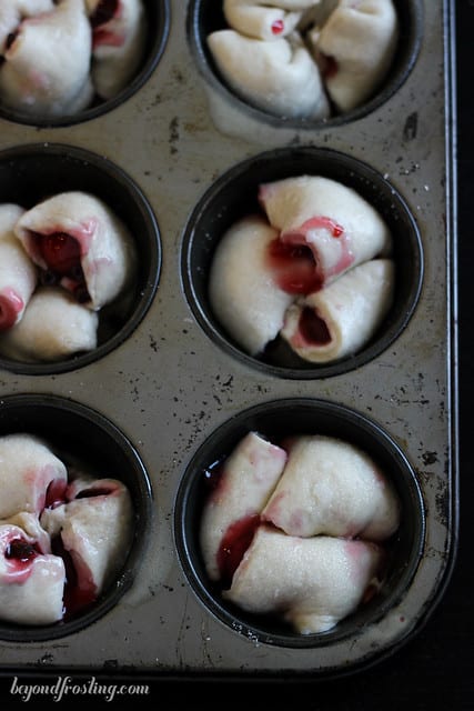 Overhead view of Chocolate Cherry Monkey Bread Muffins in a muffin tin before baking