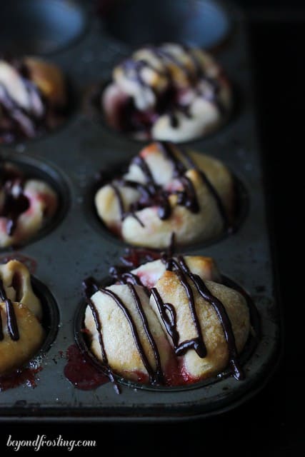Overhead view of Chocolate Cherry Monkey Bread Muffins with chocolate drizzle in a muffin tin