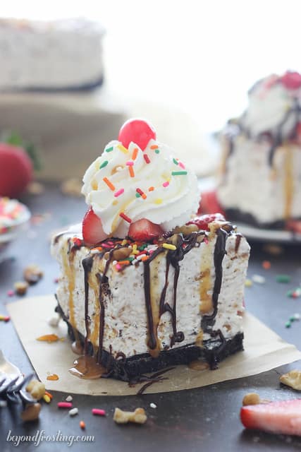 Side view of a serving of Banana Split S'mores Ice Cream Cake on a piece of parchment paper