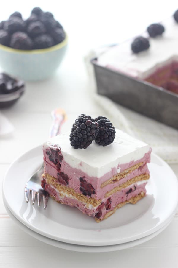 A gorgeous slice of blackberry ice cream cake that is layered with graham crackers and fresh berries. 