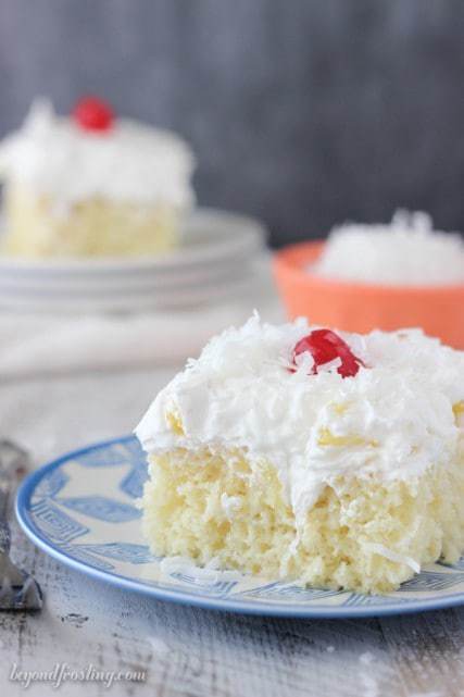 A Pina Colada Poke Cake is such a refreshing dessert! This rum spiked vanilla cake is drenched in sweetened condensed milk and topped fresh pineapple and coconut whipped cream.