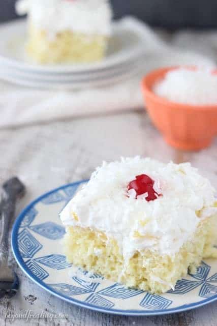 This Pina Colada Poke Cake is such a refreshing summer dessert! It's got all the Pina Colada essentials: Rum, coconut, pineapple and fresh whipped cream.