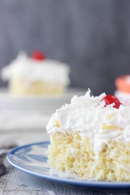 A Pina Colada Poke Cake is such a refreshing dessert! This rum spiked vanilla cake is drenched in sweetened condensed milk and topped fresh pineapple and coconut whipped cream.
