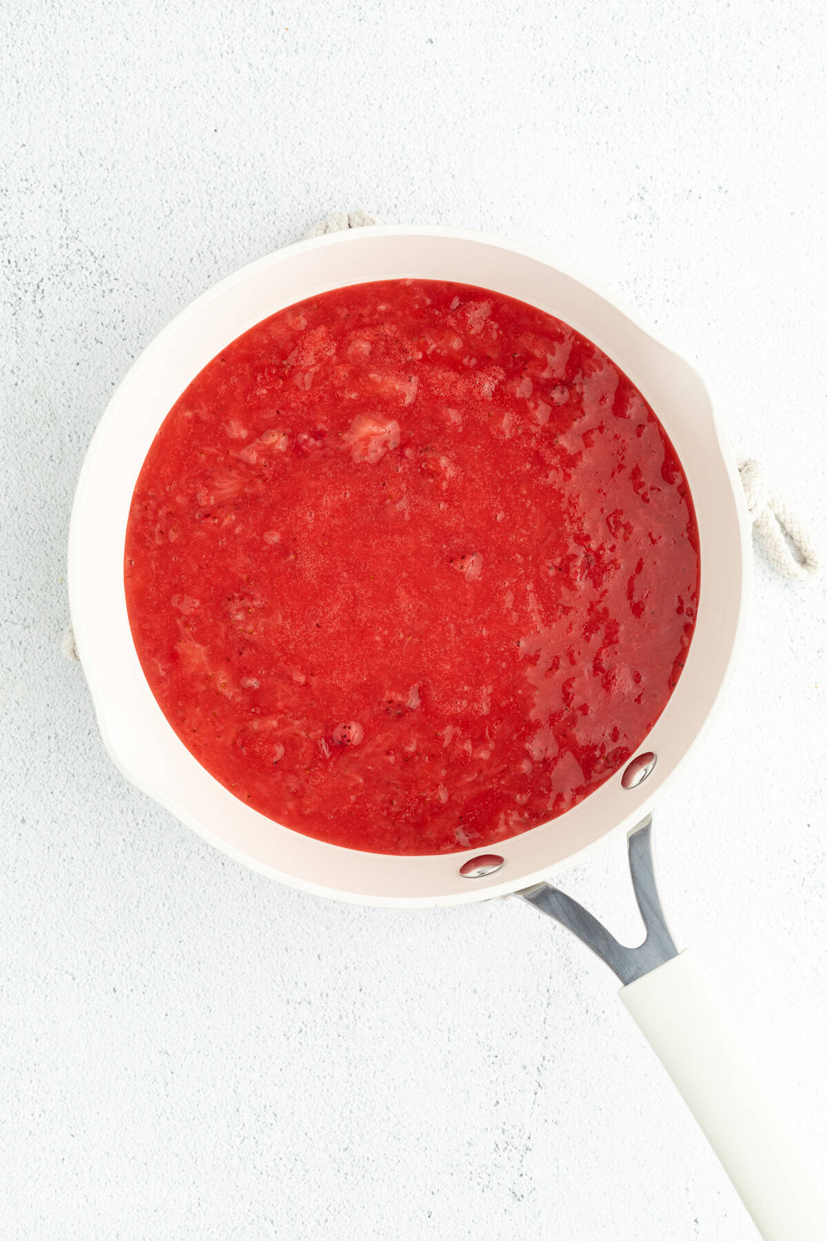 Homemade strawberry sauce in a saucepan.
