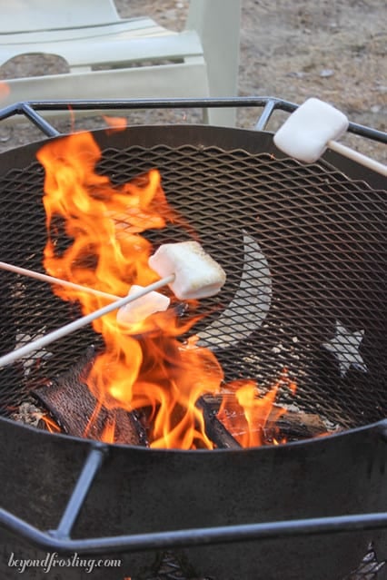 Marshmallows being toasted over a fire