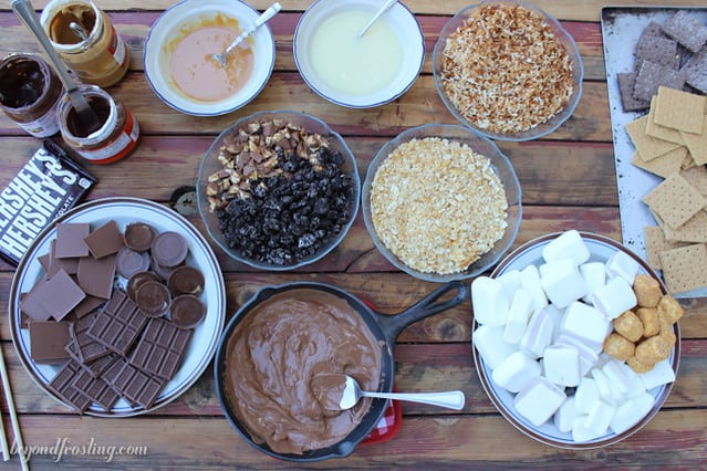 Overhead view of the DIY S'mores Fondue ingredients in bowls on a table