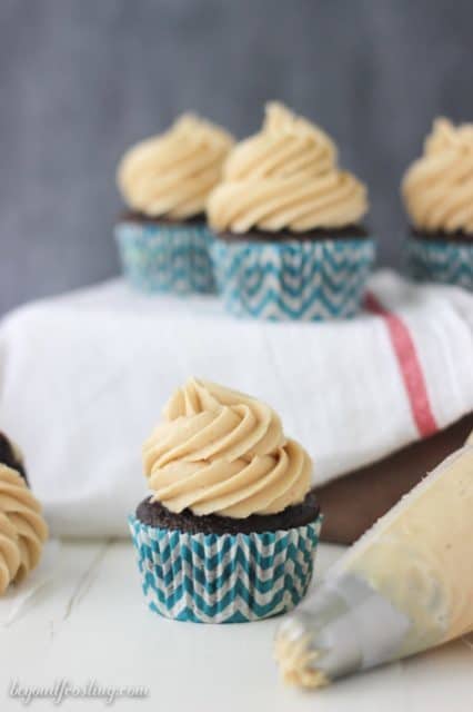 Biscoff Cheesecake Cupcakes- A chocolate cupcake with a layer of baked cheesecake inside topped with a Biscoff cream cheese frosting. You won't get enough of these cupcakes!