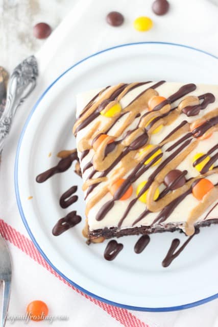 This rich chocolate poke cake is loaded with Reese’s, smothered in chocolate pudding and topped with peanut butter whipped cream and drizzled with peanut butter and chocolate.