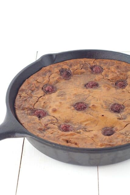 Large skillet baked brownie filled with cherries. Top this Black Forest Skillet Brownie with chocolate whipped cream