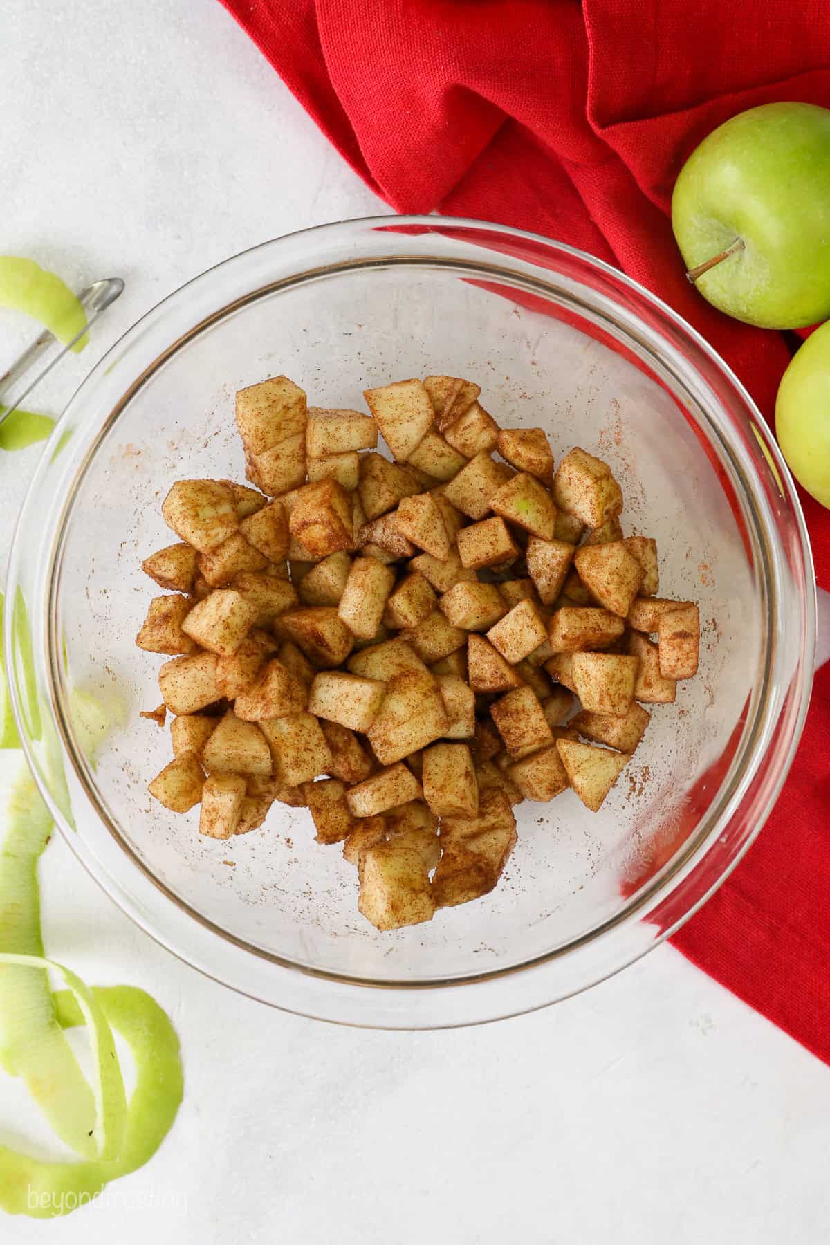 Diced cinnamon apples in a glass bowl.