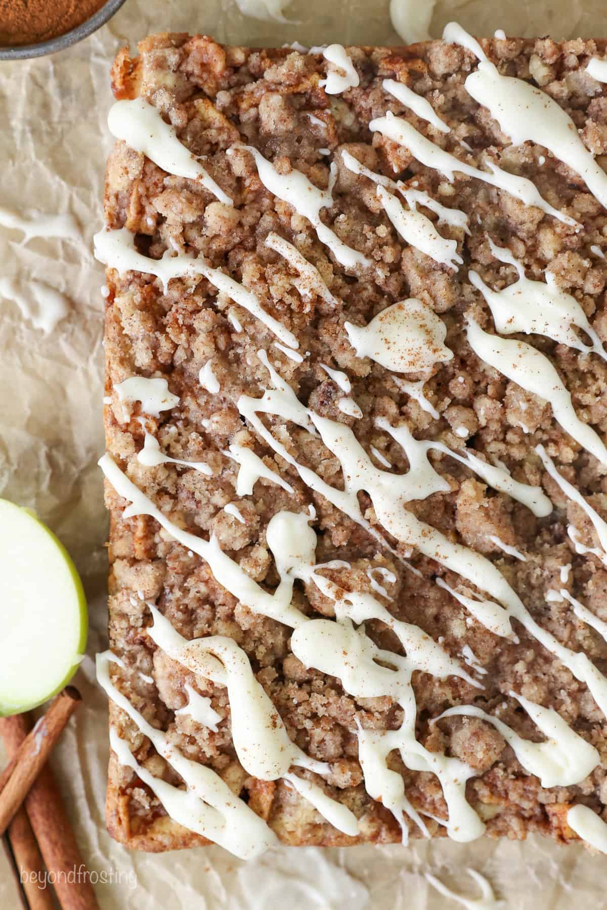 Overhead view of apple coffee cake drizzled with glaze.