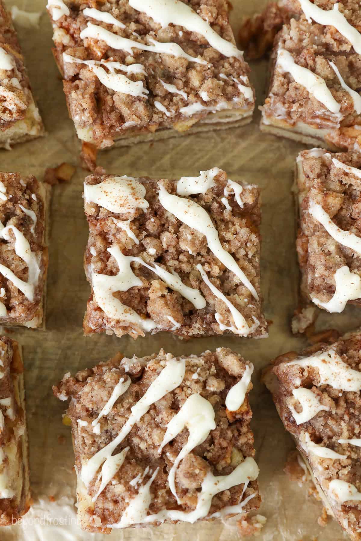 Overhead view of apple coffee cake slices drizzled with glaze.