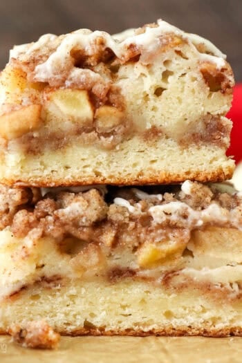 Side view of a two apple coffee cake slices stacked on top of one another.