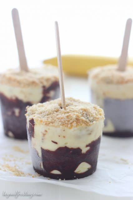 Chocolate coated Banana Cream Pie Popsicles. These are so simple to make with mashed bananas, vanilla pudding and whipped cream. This is all topped with a Nilla Wafer crust. 
