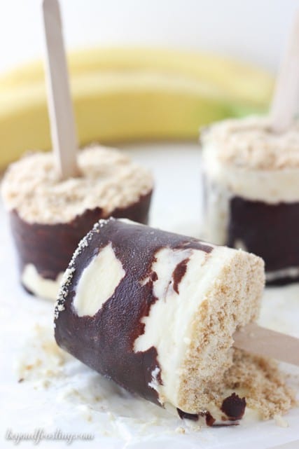 Three Banana Cream Pie Popsicles with a Chocolate Coating