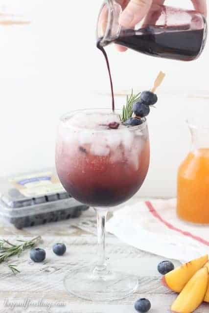 This Blueberry Peach Spritzer features an easy, homemade blueberry syrup with peach juice and prosecco. 